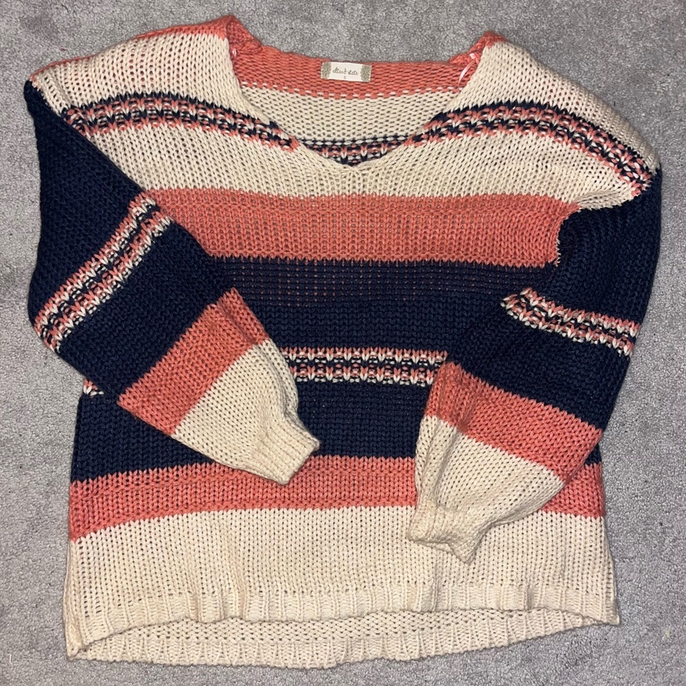 Knitted over-the-shoulder pullover.